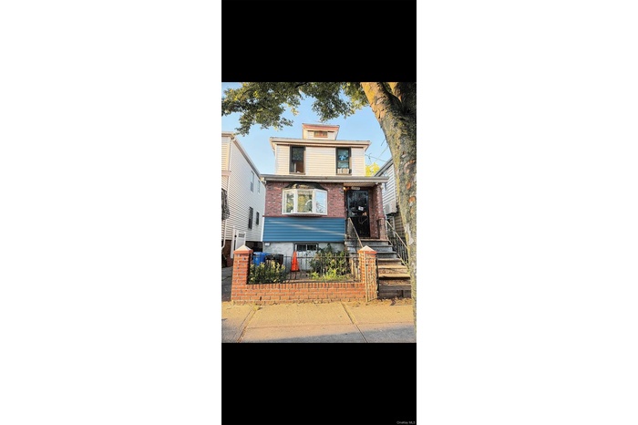 Traditional style home with brick siding and a fenced front yard
