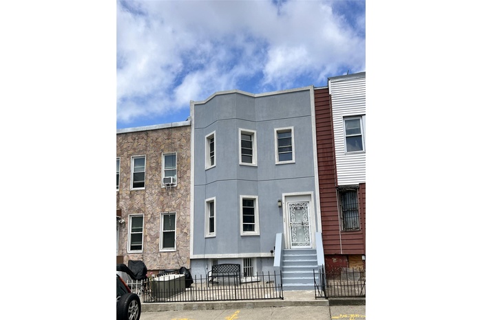 View of front of house with a fenced front yard, stucco siding, and entry steps