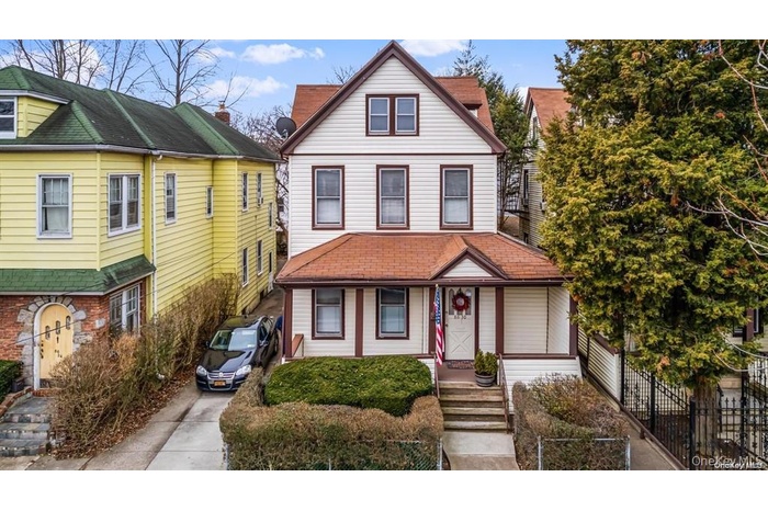 View of front of home featuring a shingled roof and a chimney