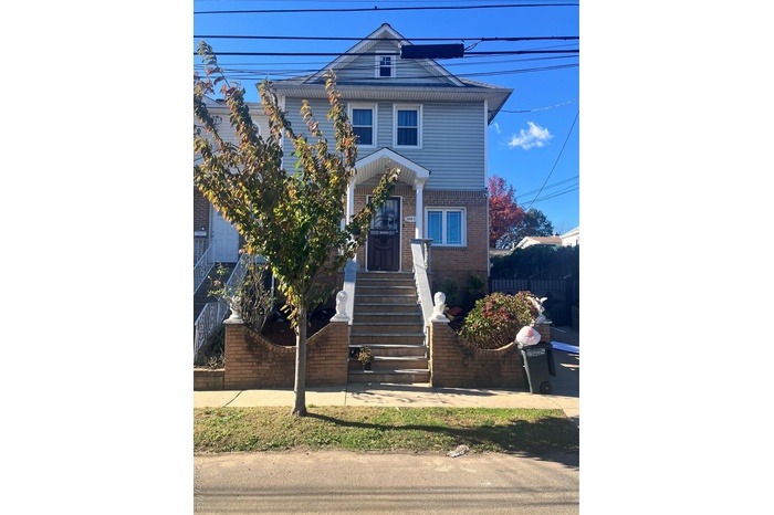 View of front of home featuring brick siding