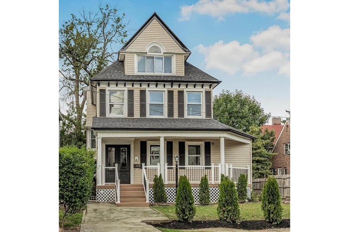 View of front of property featuring covered porch and roof with shingles