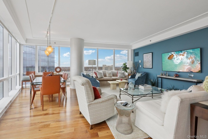 Living room with light wood-type flooring and expansive windows
