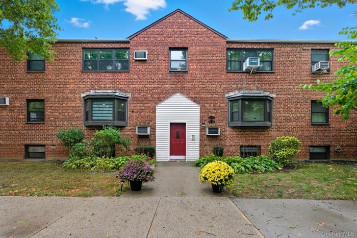 Colonial home featuring brick siding