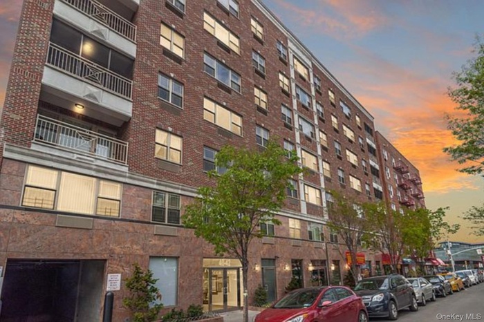 Property at dusk featuring a view of apartment building / complex