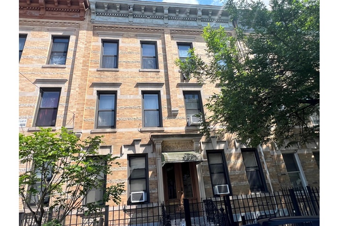 View of property featuring a fenced front yard