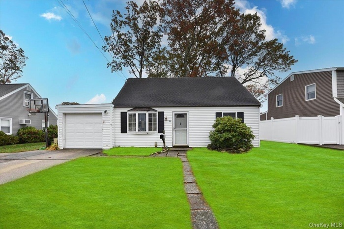 View of front of home featuring driveway, a shingled roof, and a garage