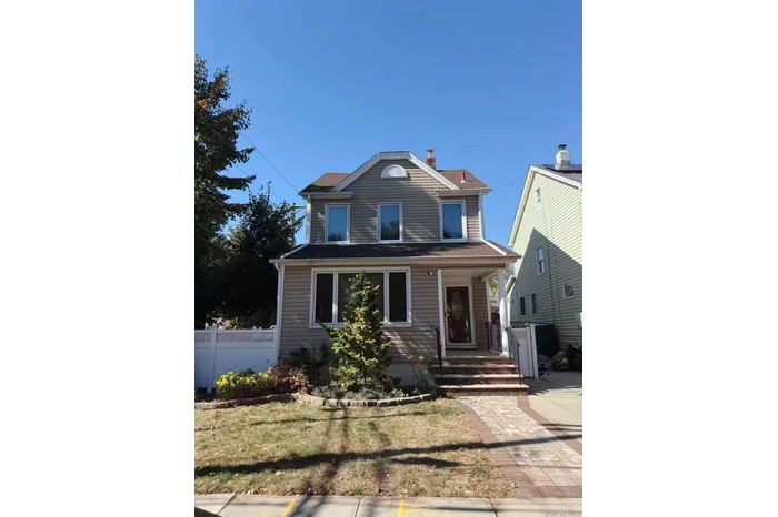 View of front of property with a porch and a chimney
