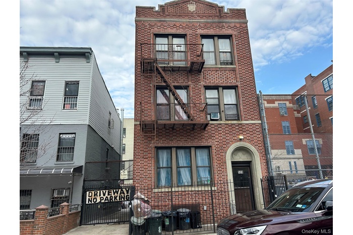 Townhome / multi-family property featuring cooling unit and brick siding