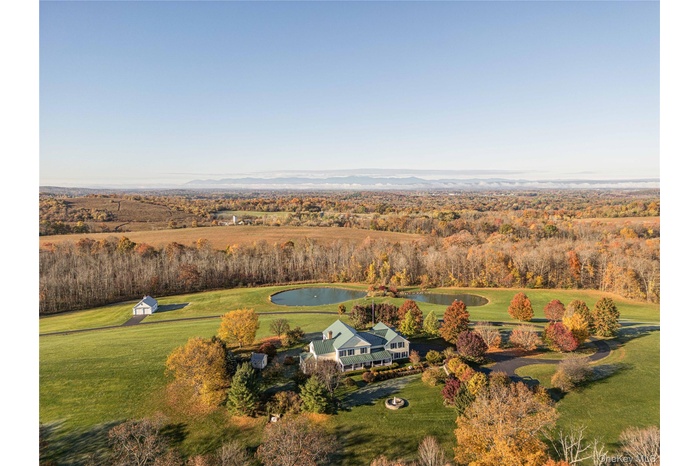 Aerial view of a nearby body of water and a forest