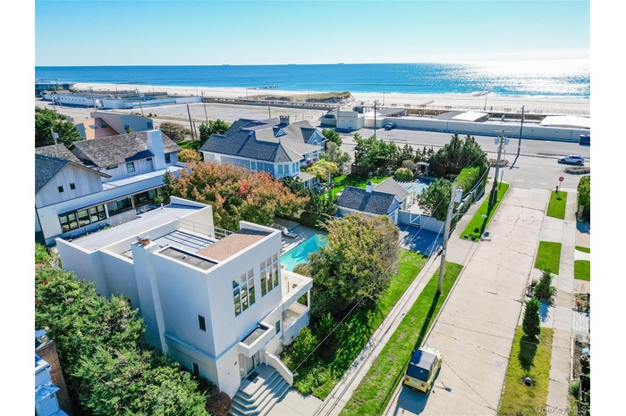 Aerial perspective of suburban area featuring waterfront with a beach