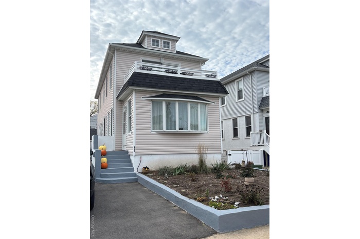 View of front of home featuring roof with shingles