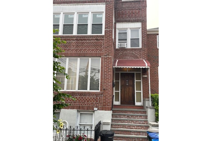 Townhome / multi-family property featuring cooling unit and brick siding