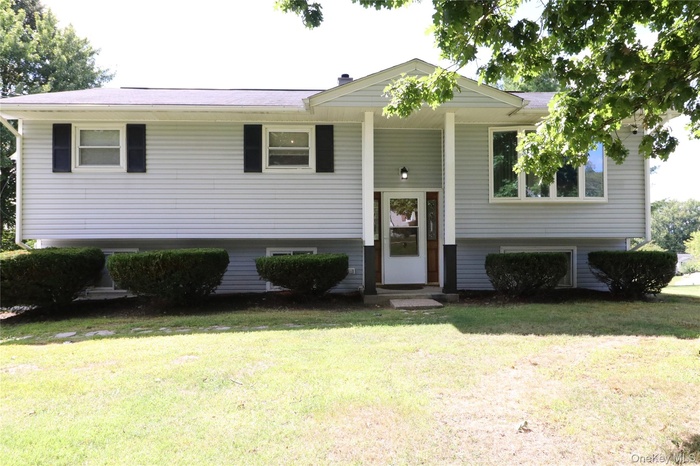Bi-level home with a front lawn