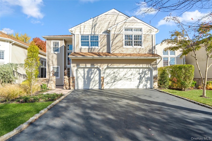 View of front of house with driveway and a garage