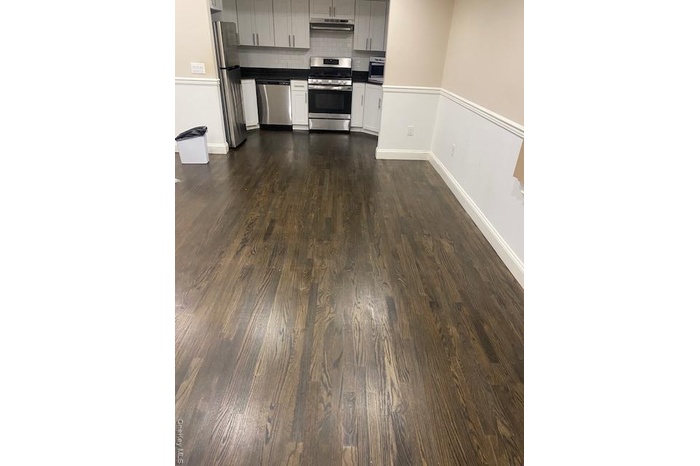 Kitchen featuring range, dark wood-style flooring, backsplash, refrigerator, and dishwasher