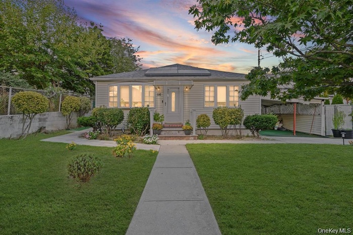 Bungalow-style home with an attached carport and solar panels