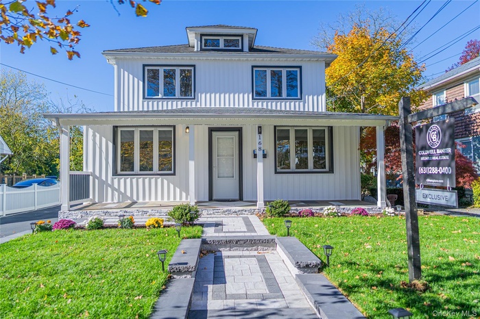 Traditional style home featuring covered porch and board and batten siding