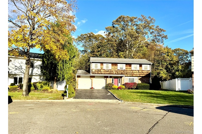 View of front of home with driveway and a garage