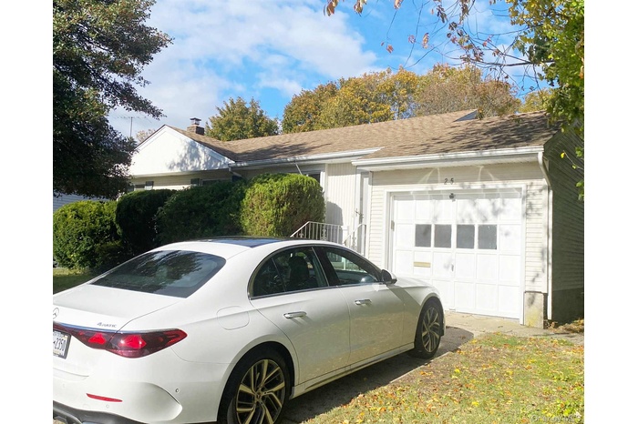View of home's exterior with a garage and roof with shingles