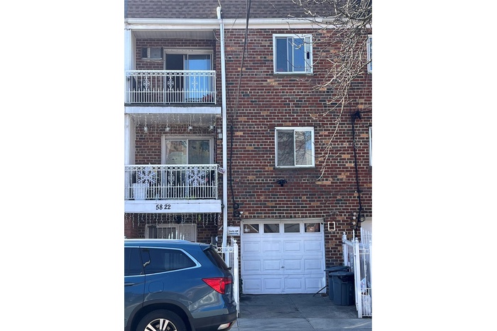 View of building exterior featuring a garage