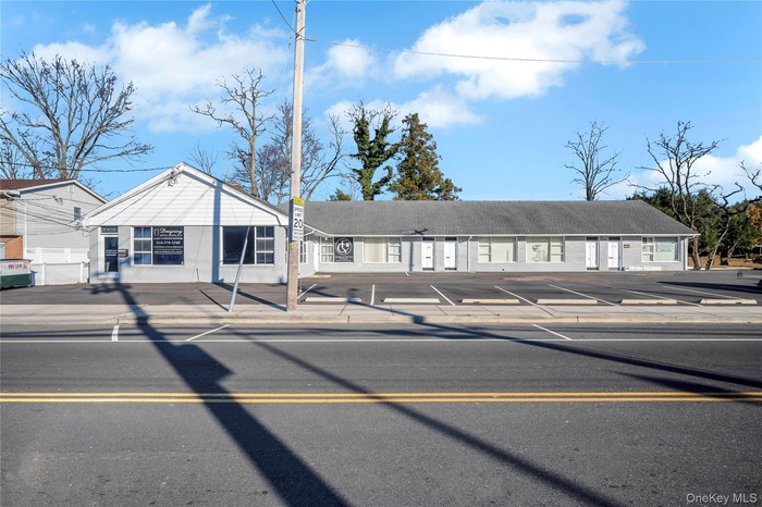 View of building exterior with uncovered parking
