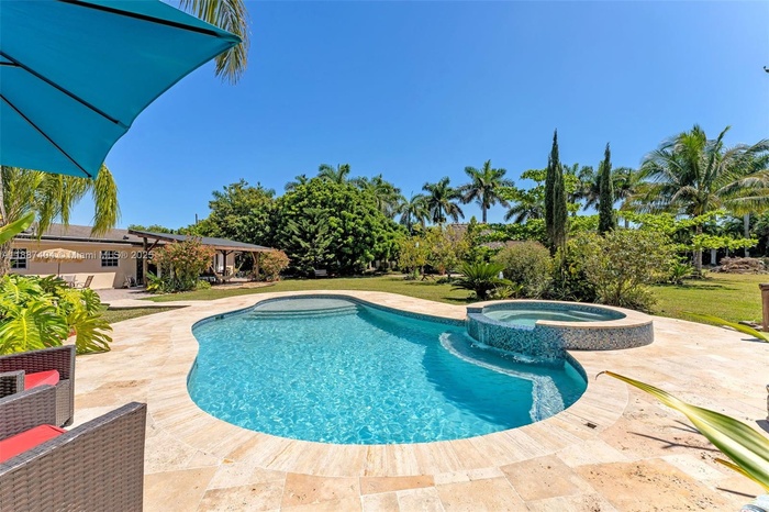 La Chakana ~ pool / spa with travertine pavers adjacent to the entertainers tiki hut WITH rear view of home