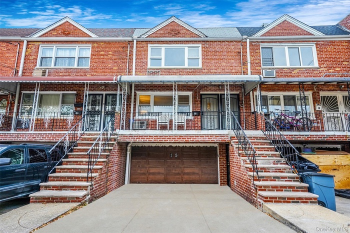 Traditional home featuring stairs, driveway, brick siding, and a porch