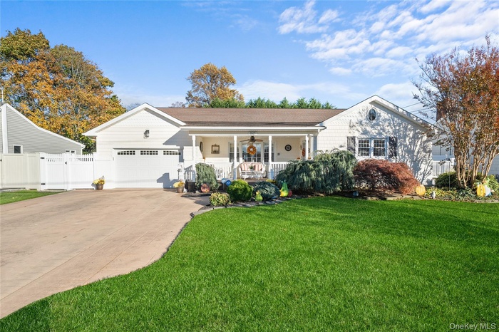 Ranch-style home featuring a porch, concrete driveway, and a garage