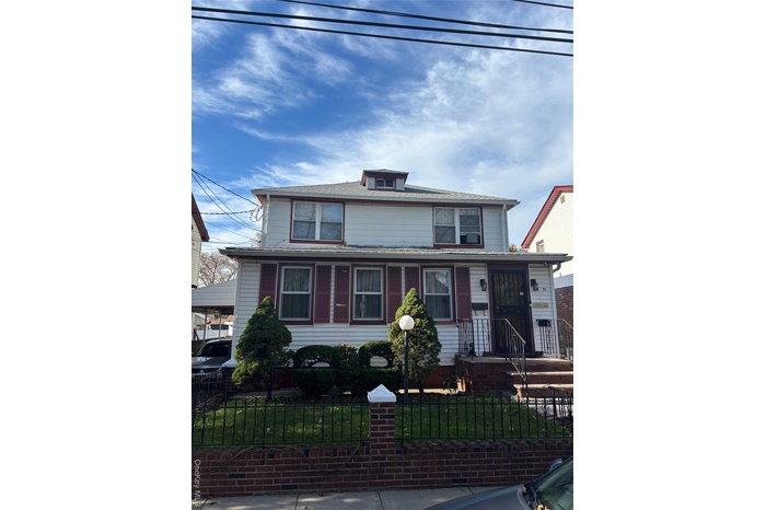 American foursquare style home with a fenced front yard