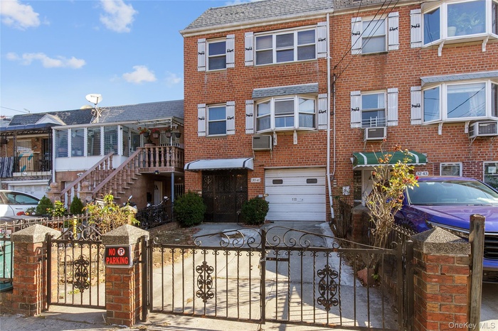 View of front of house featuring a gate, brick siding, and a fenced front yard