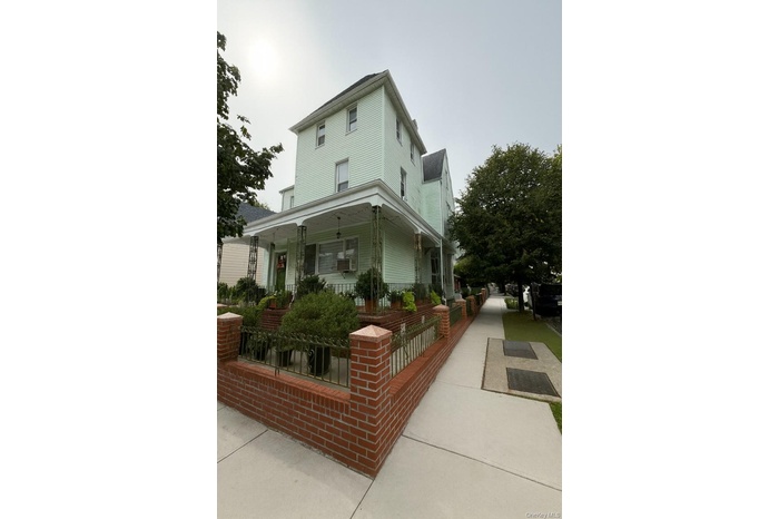 View of side of property with covered porch