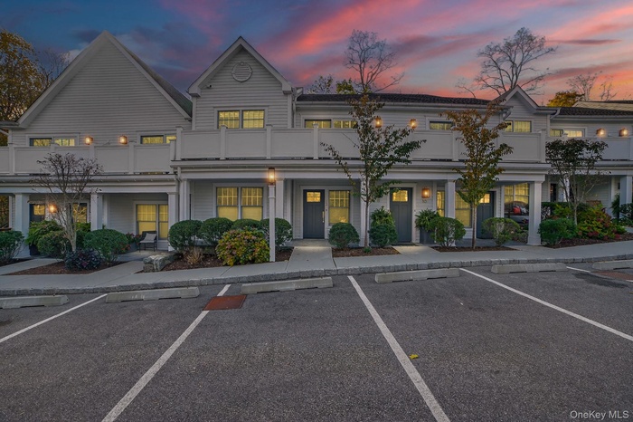 View of property featuring uncovered parking