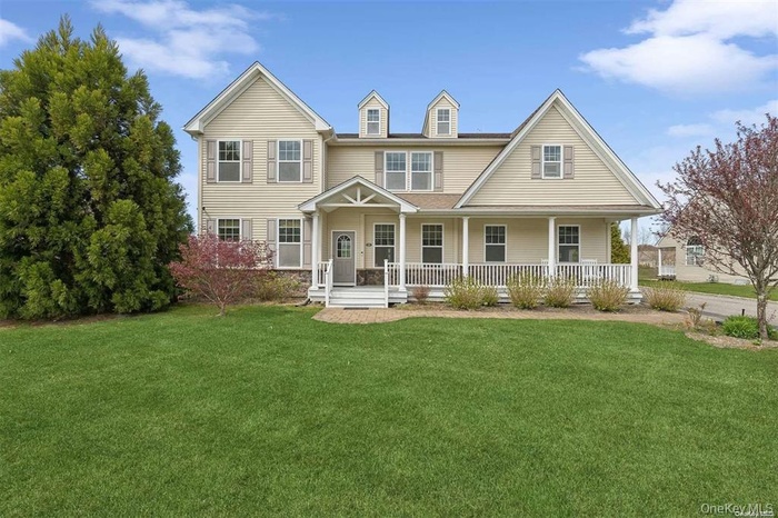 View of front of home featuring covered porch and a front lawn
