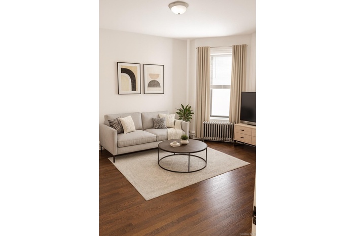 Living area with radiator and dark wood-type flooring