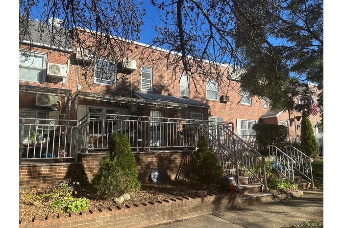 Back of property featuring brick siding and stairway