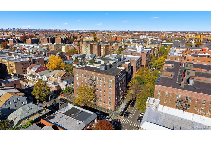 Aerial view of property and surrounding area with nearby urban area