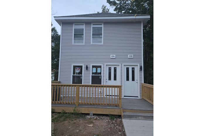Back of property with a wooden deck