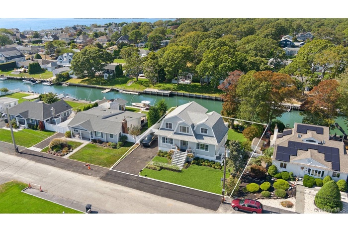 Aerial view of residential area featuring a nearby body of water