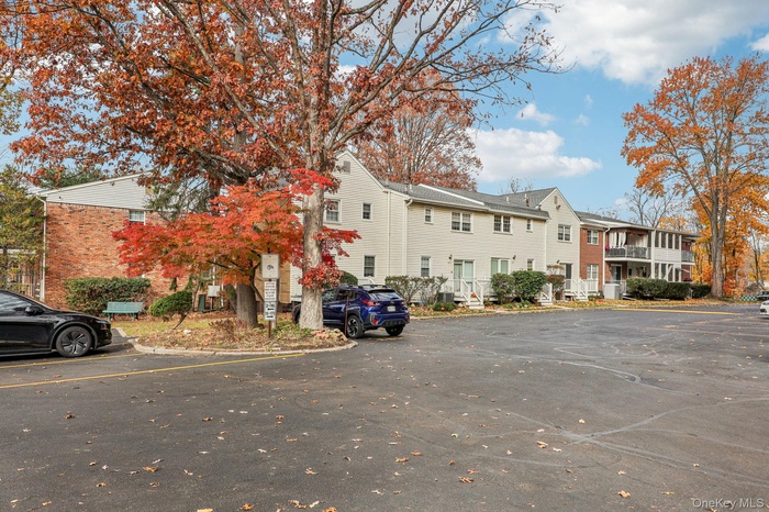 View of building exterior featuring uncovered parking and a residential view