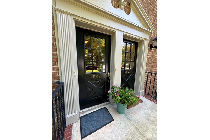 Doorway to property featuring brick siding