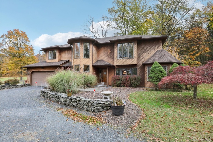 View of front of house with gravel driveway