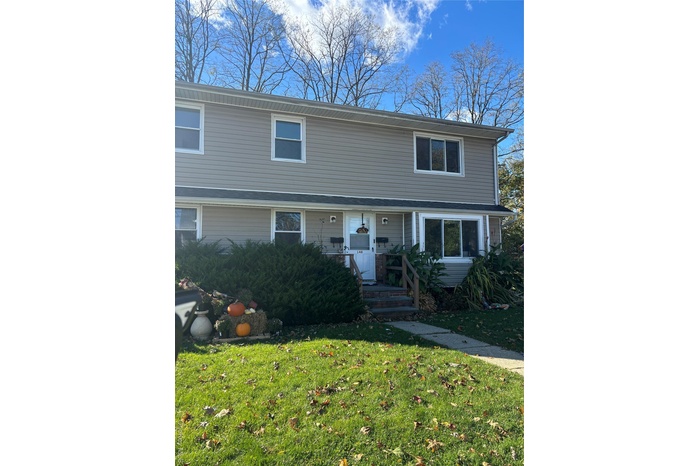 Traditional-style home with a front yard