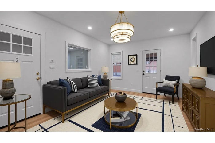 Living room featuring light wood-type flooring and recessed lighting