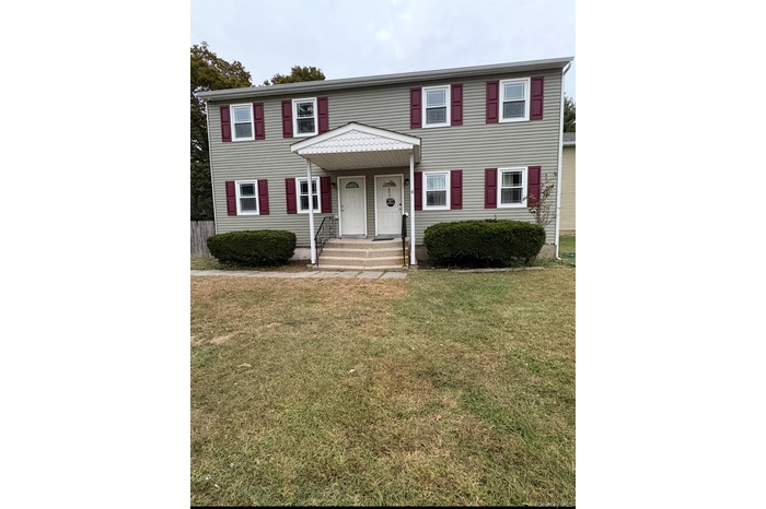 View of front of home with a front lawn and a porch