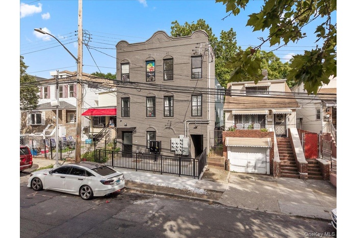 View of front of house featuring brick siding and a garage