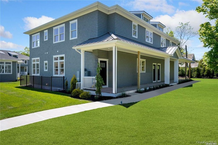 Back of property with a standing seam roof, covered porch, and a metal roof