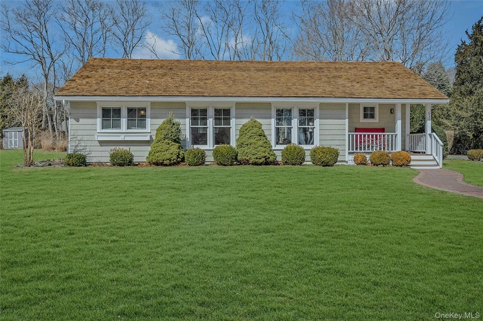 View of front of property featuring a front lawn and a porch