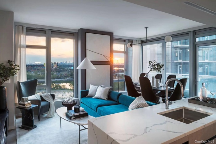 Living area with a wall of windows, a view of city, and concrete flooring