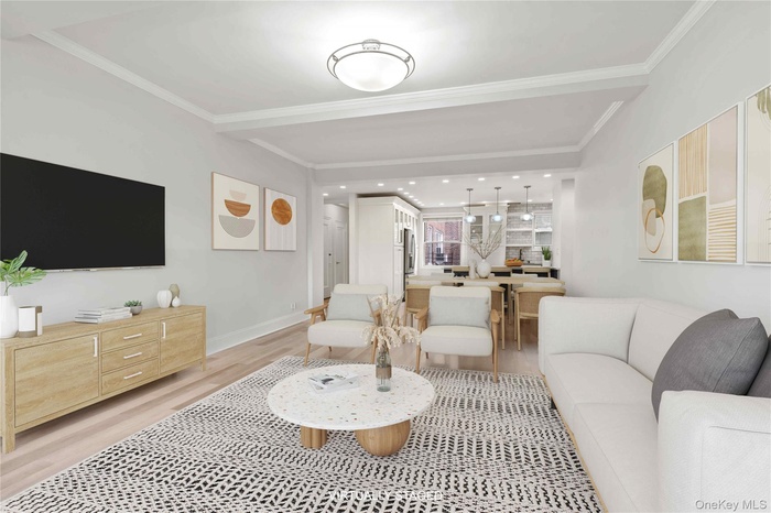 Living room featuring light wood finished floors, crown molding, and recessed lighting