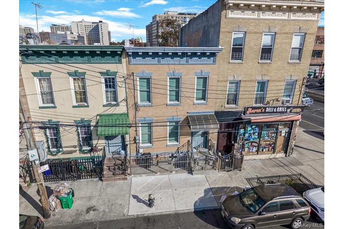 Back of property featuring brick siding and a city view